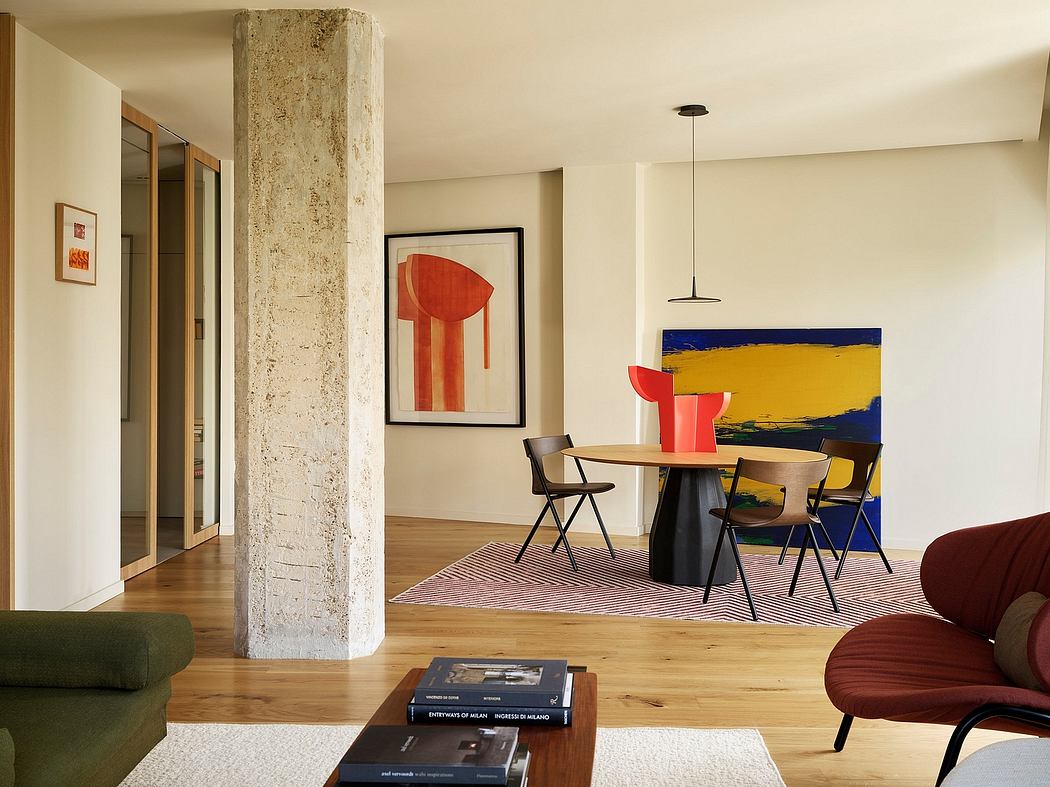Minimalist interior with exposed concrete column, abstract art, and modern furnishings.