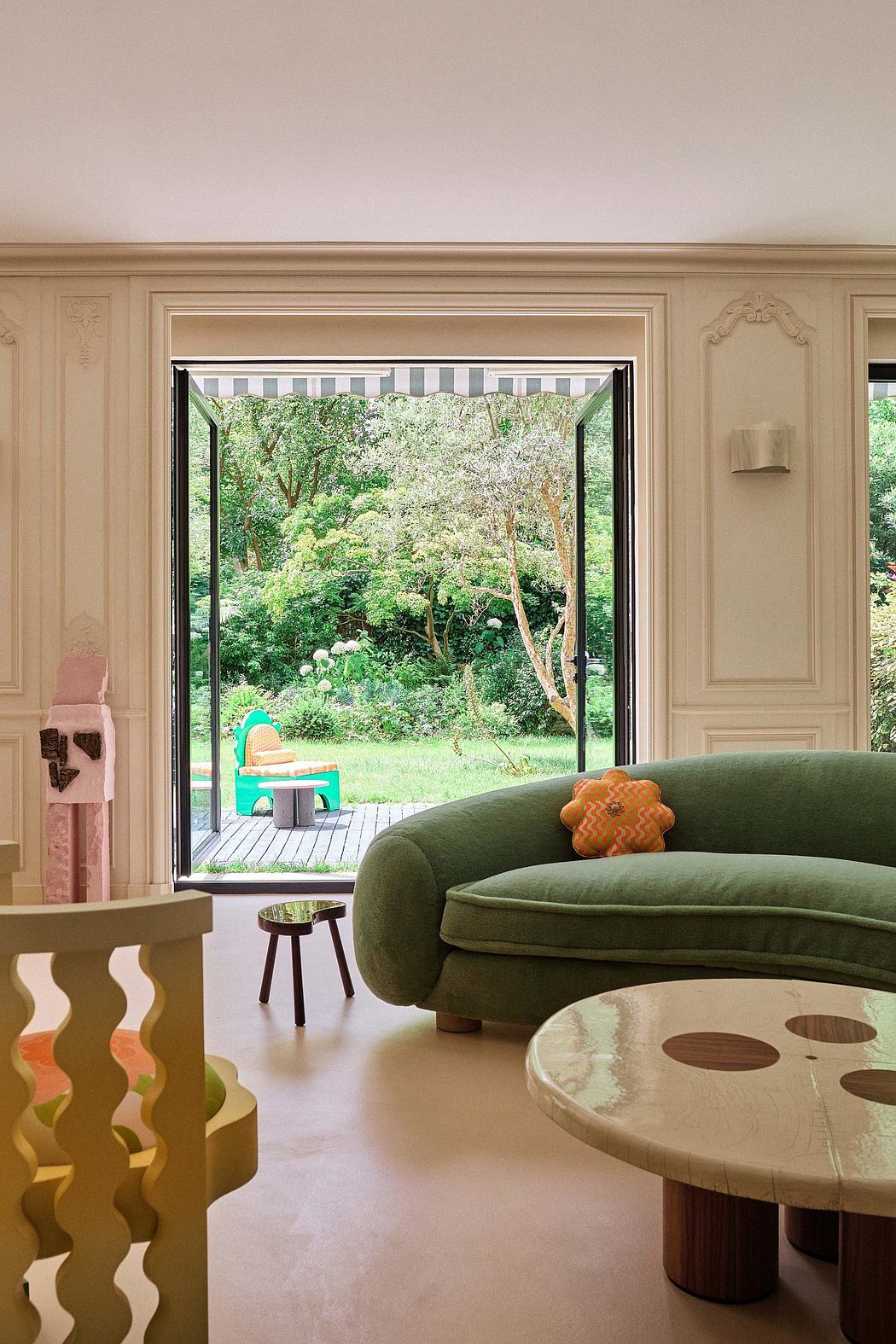 A warm, cozy living room with french doors opening to lush greenery outside.