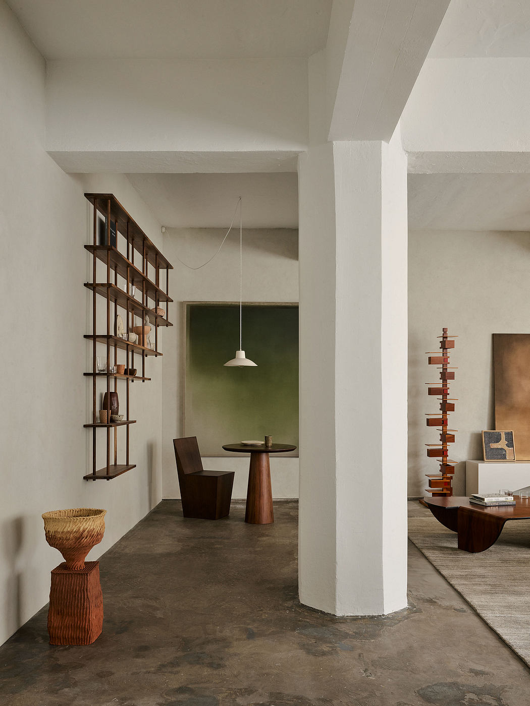 A minimalist and modern interior design with a wooden shelf, table, and sculptural elements.