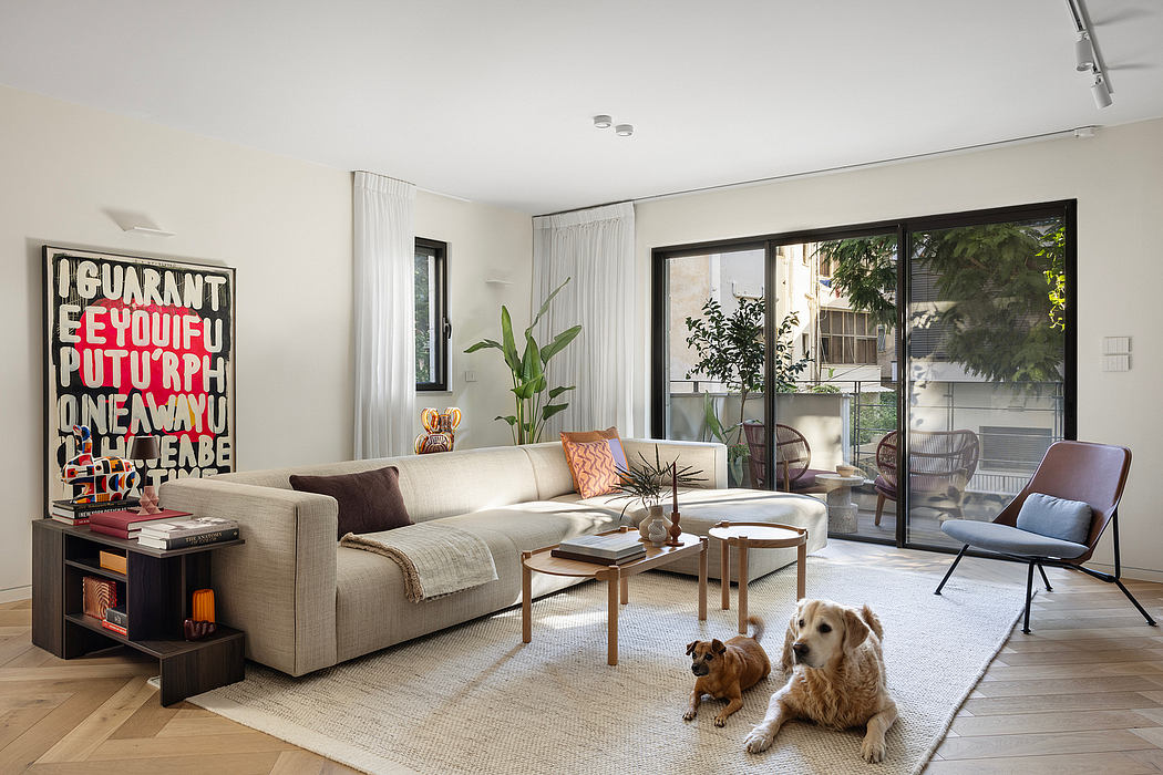 Modern, airy living room with sleek furniture, large windows, and colorful artwork.