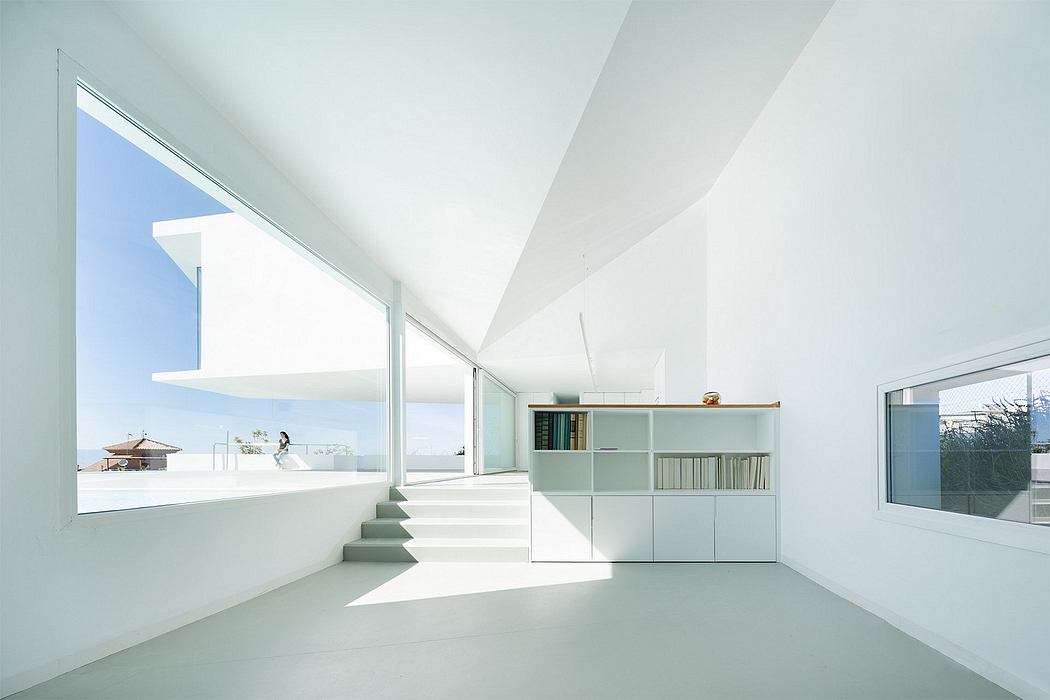 Minimalist architectural interior with white walls, large windows, and built-in shelving.