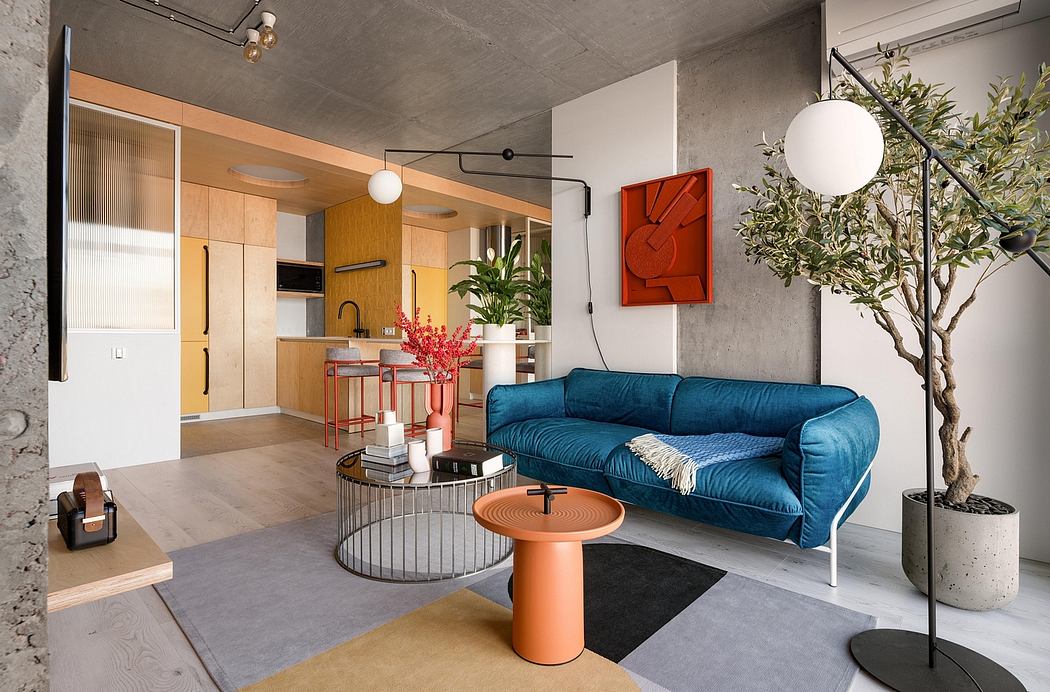 Contemporary open-plan living space with concrete walls, colorful furniture, and plants.