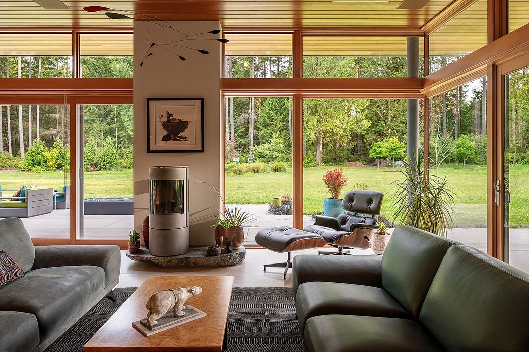 Expansive glass walls, minimalist furnishings, and earthy tones create a modern, nature-inspired interior.
