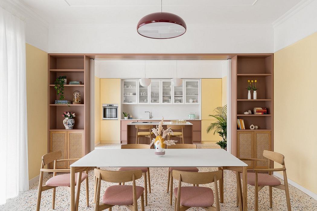 Bright, inviting kitchen-dining space with wood furnishings, glass cabinets, and chic lighting.