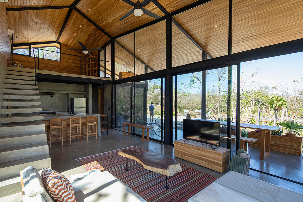Rustic cabin-like interior with wood beams, large windows, and modern furnishings.