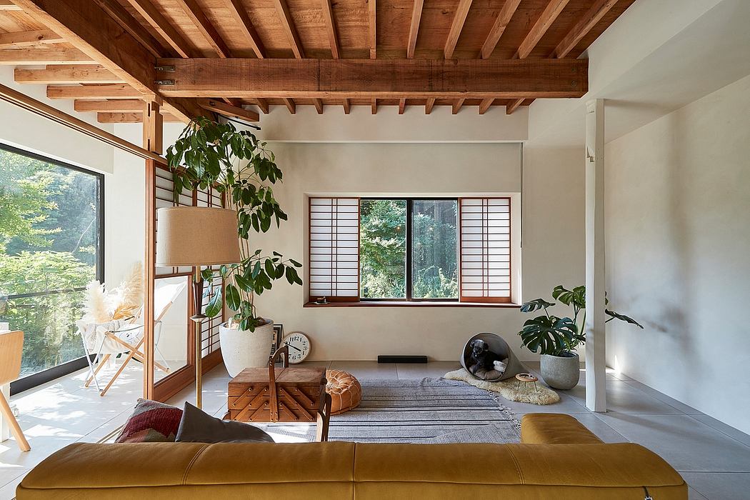 Rustic wooden beams, large windows, and natural decor create a cozy, modern interior.