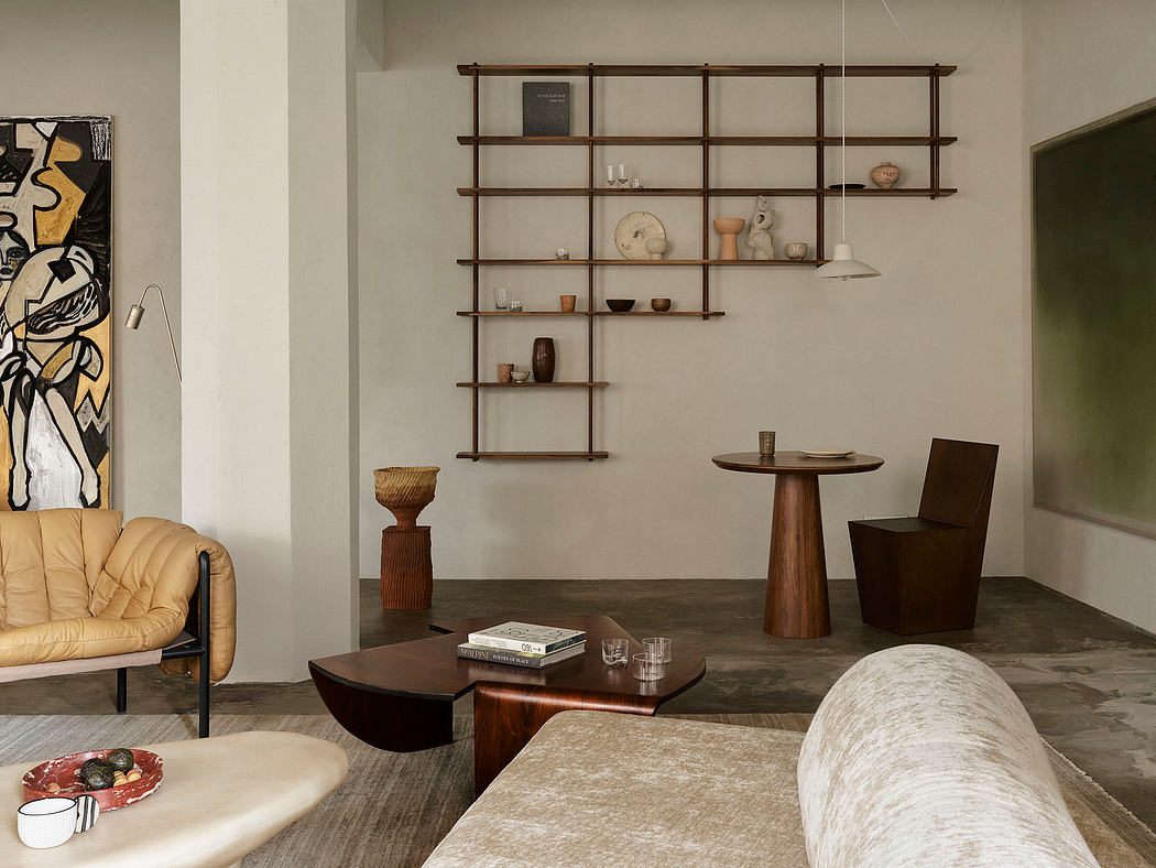 Minimalist living room with wooden shelving, curved furniture, and earthy tones.