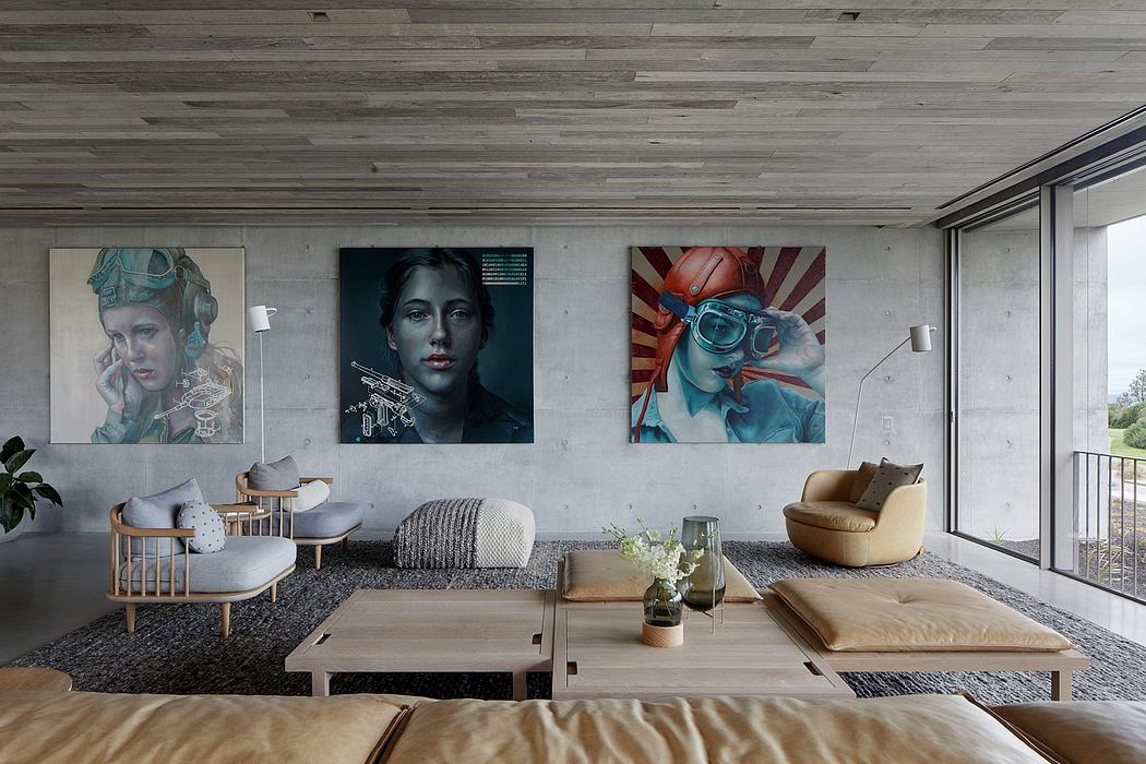 Minimalist living room with earthy tones, modern artwork, and concrete walls.