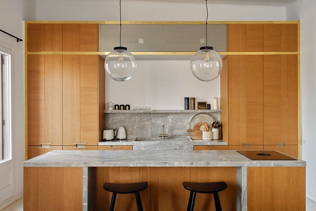 The kitchen features sleek wood cabinets, marble countertops, and pendant lighting.