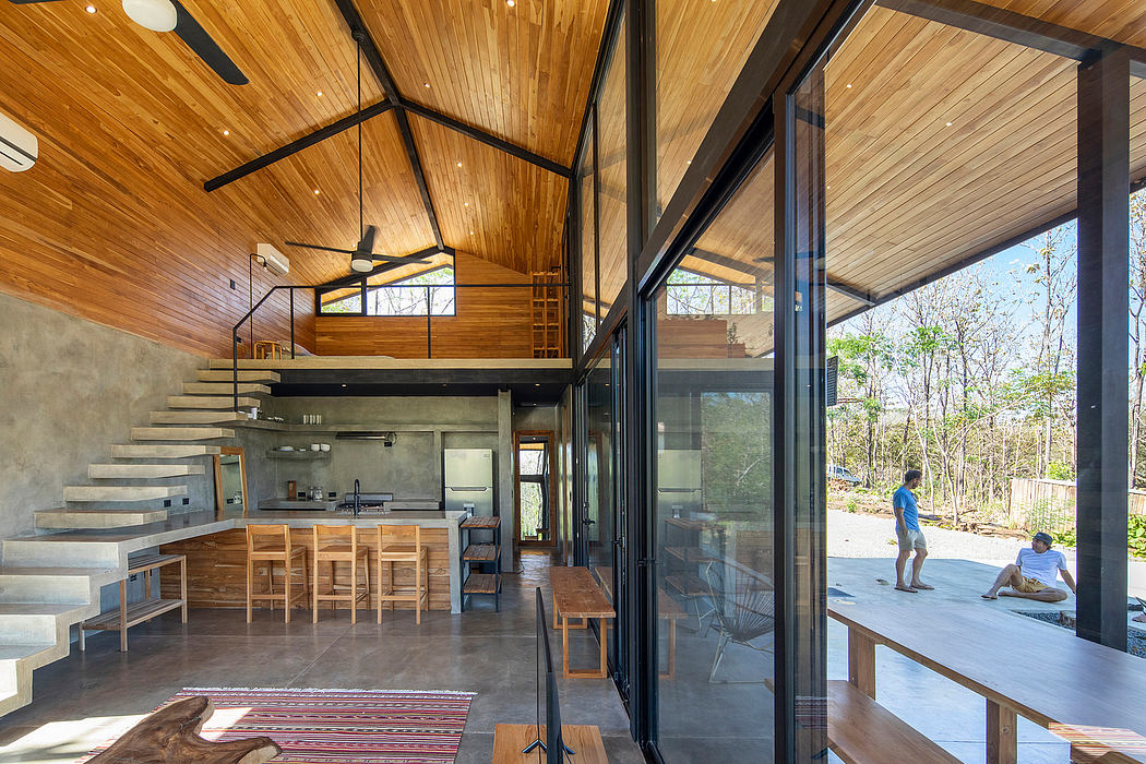 Spacious modern cabin with wood-paneled ceiling, large glass windows, and contemporary furnishings.
