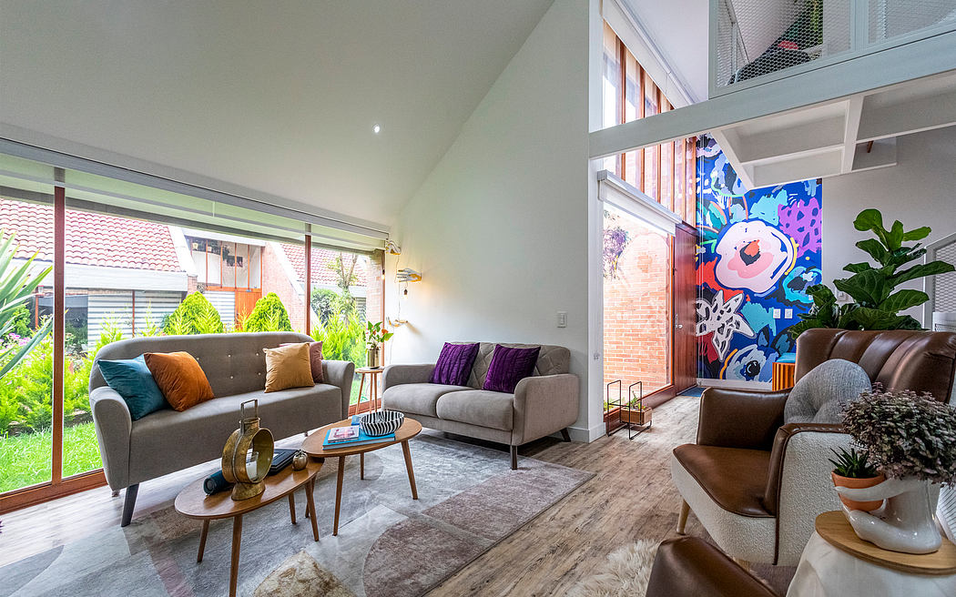 A modern, open-concept living space with a vibrant mural, plush seating, and natural light.
