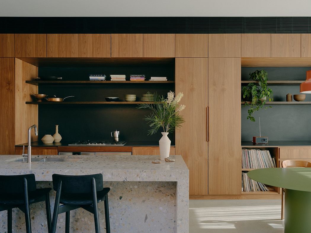 A modern kitchen with wooden cabinetry, open shelves, and a stone countertop.