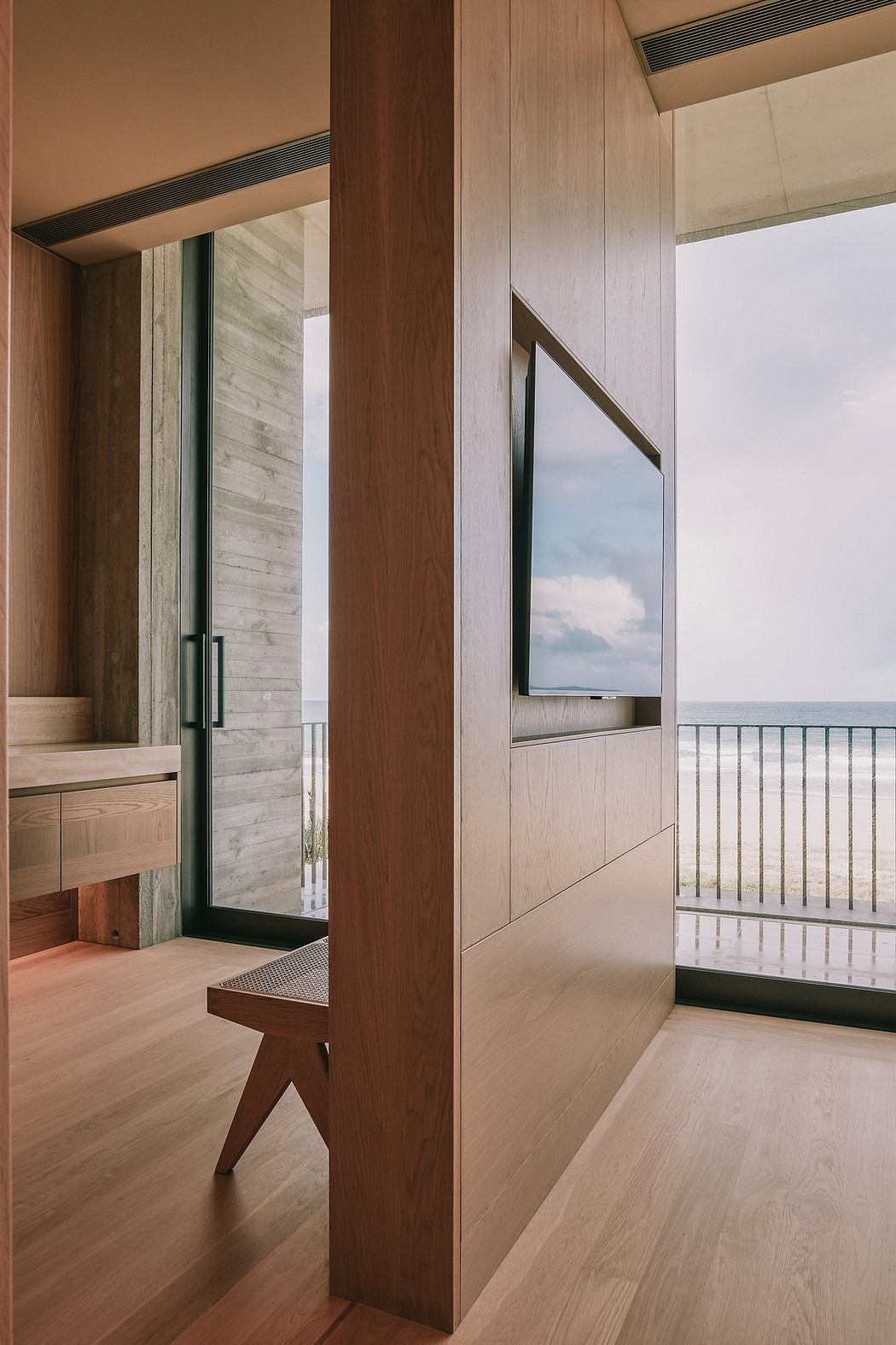 The image showcases an elegant modern interior with wooden accents, floor-to-ceiling windows, and a balanced, harmonious design.