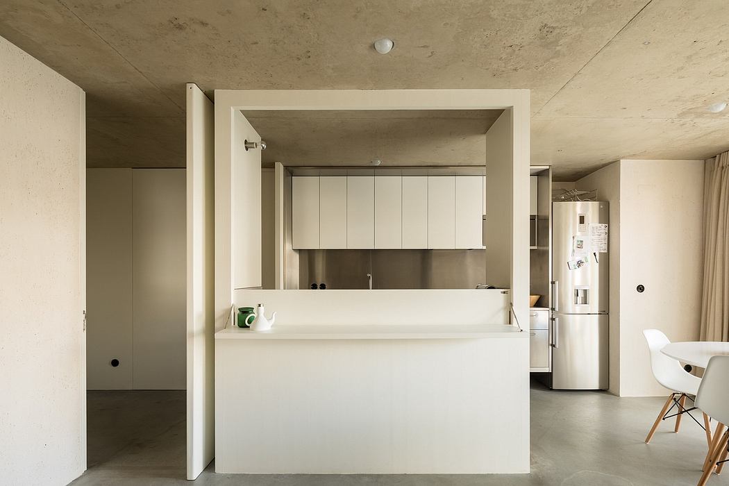 Minimalist kitchen with clean lines, sleek white cabinetry, and integrated appliances.