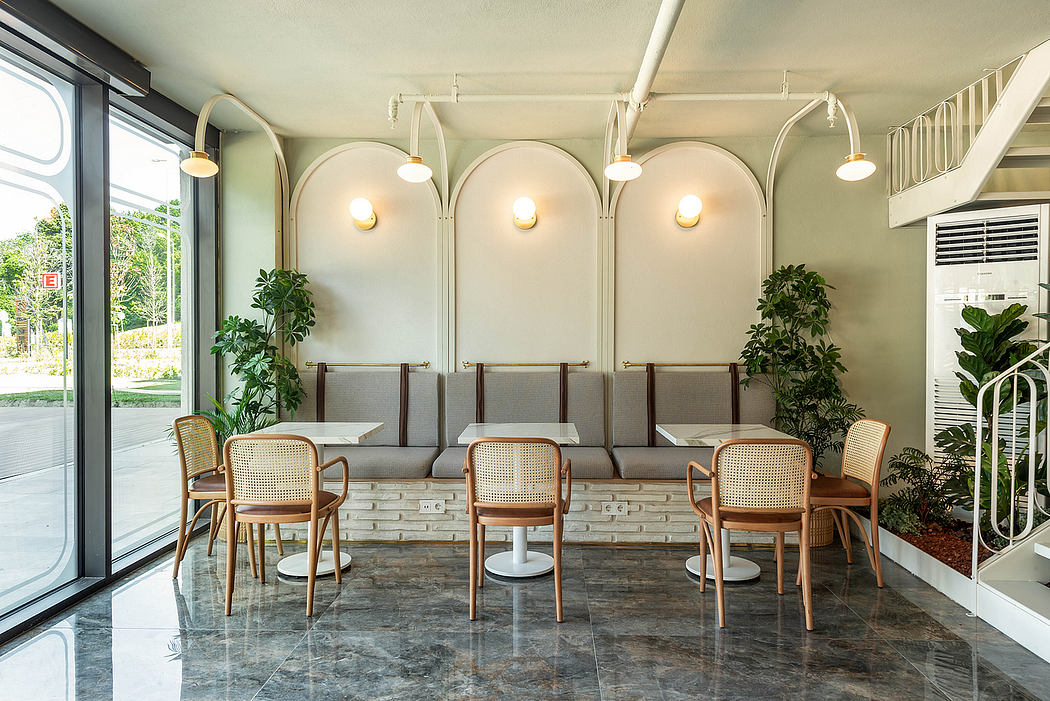 Modern interior with arched alcoves, bamboo furnishings, and lush greenery against a marble floor.