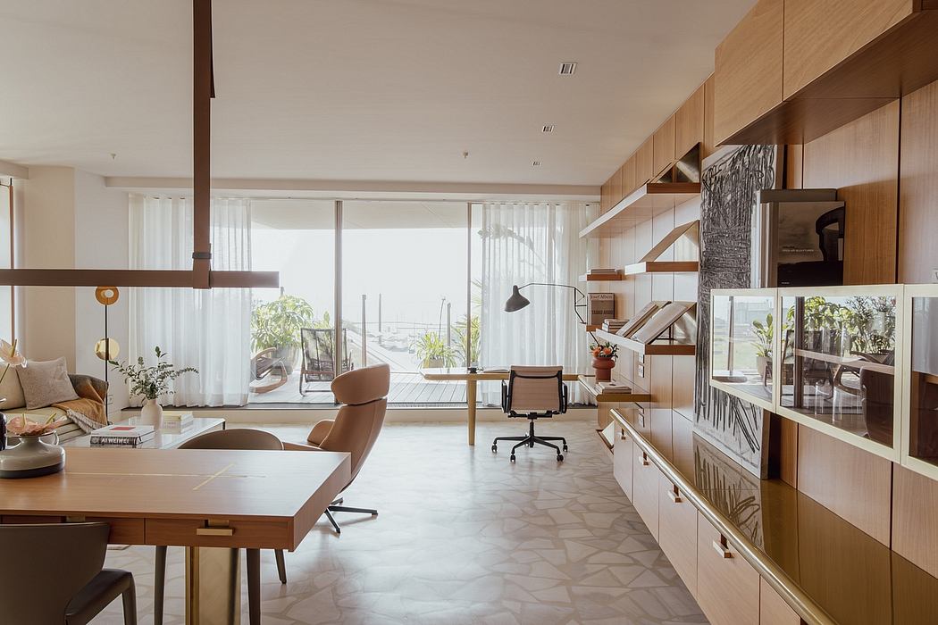 Modern, open-concept living space with wooden furnishings, large windows, and natural light.