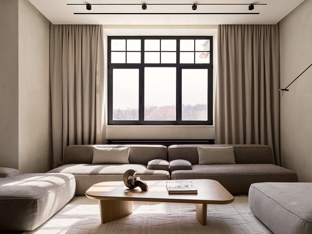 A sleek, contemporary living space with black-framed windows, a cozy sectional, and a wooden coffee table.