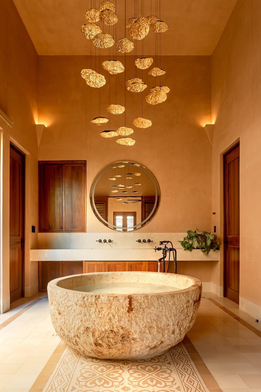 Ornate lighting fixtures, intricate tile work, and a natural stone bathtub create a luxurious ambiance.
