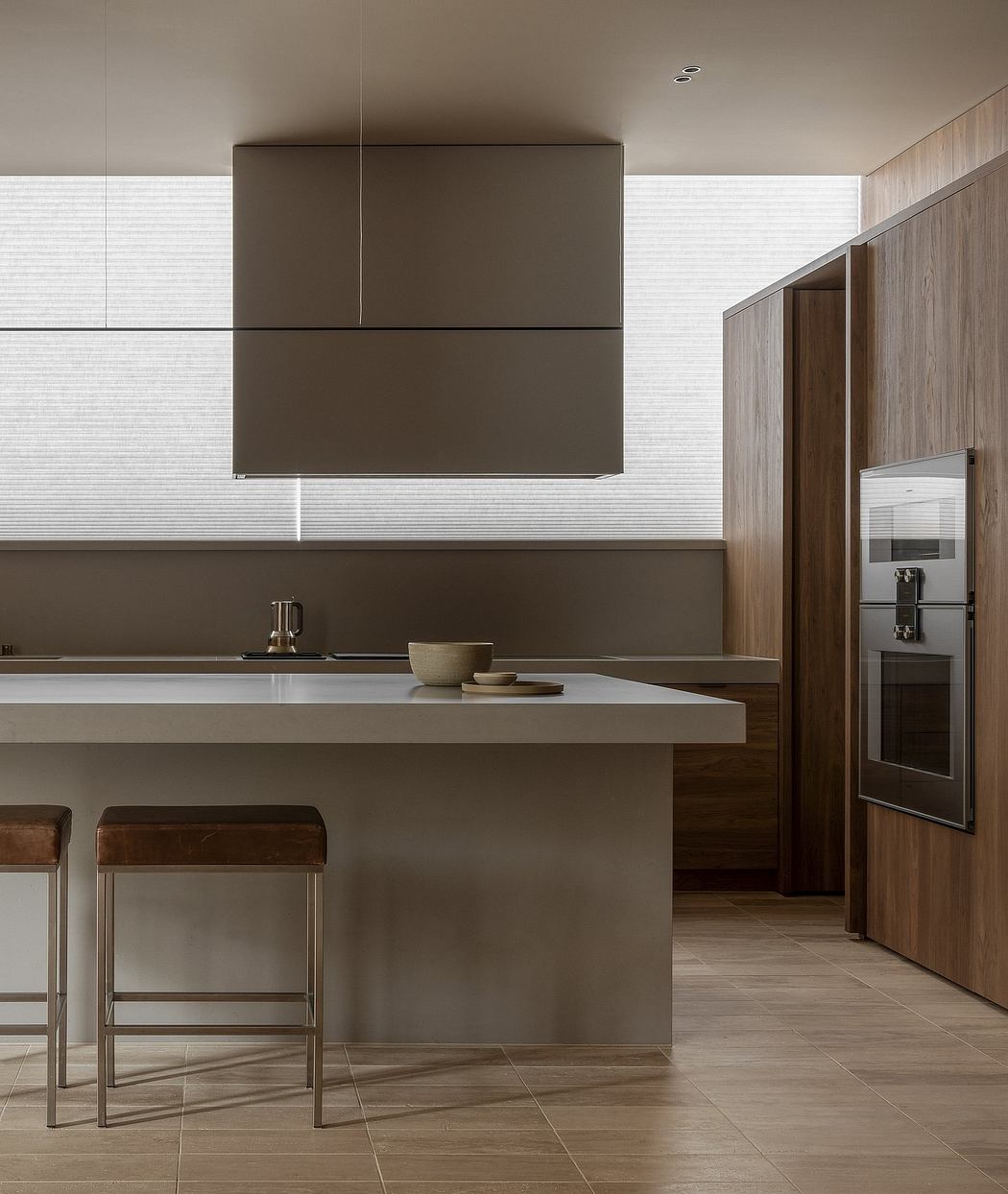Modern minimalist kitchen with sleek brown cabinets, gray countertops, and wooden accents.