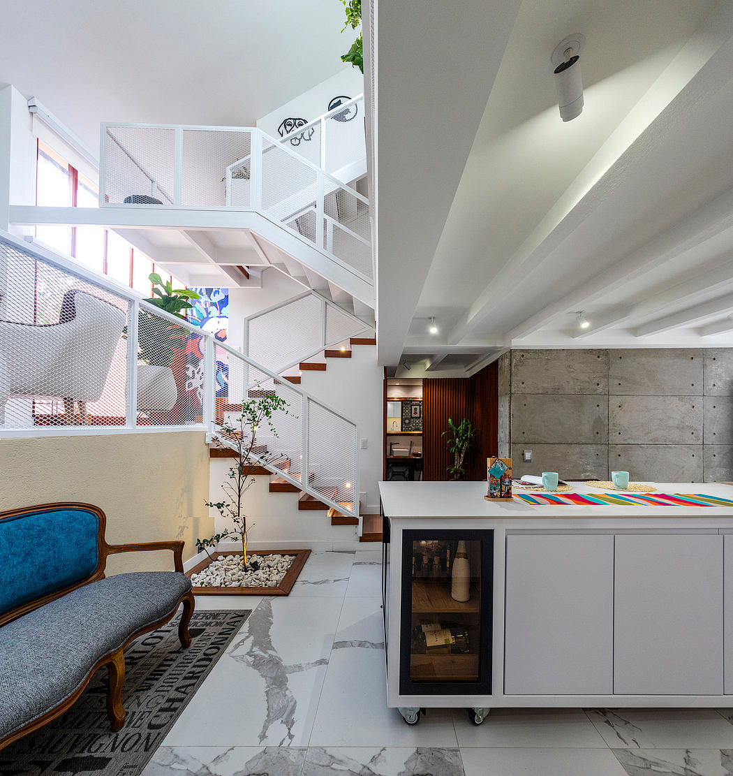 Modern open-plan interior with sleek white walls, concrete accents, and a vibrant dining area.