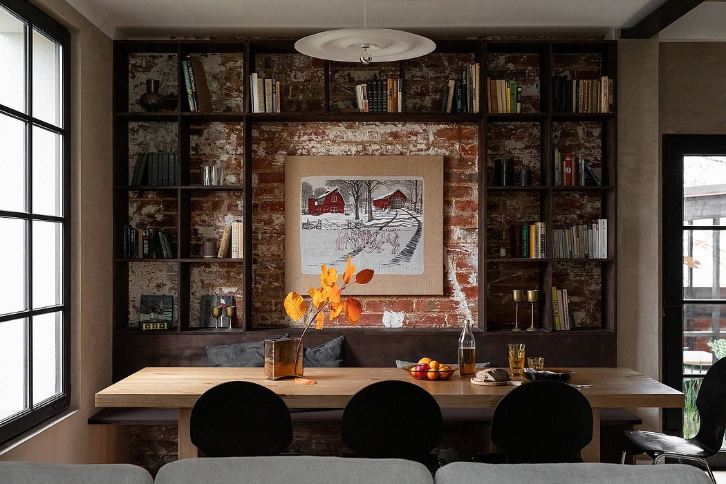 Rustic brick walls, wooden shelves, and a large dining table create a cozy, inviting space.