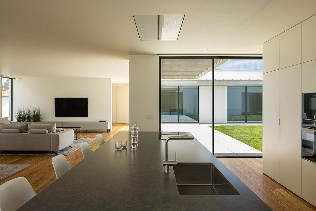 Spacious modern interior with floor-to-ceiling glass walls, open-concept design.