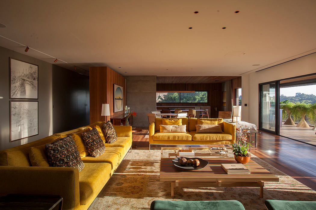 Spacious living room with warm wooden tones, sleek furniture, and panoramic views.