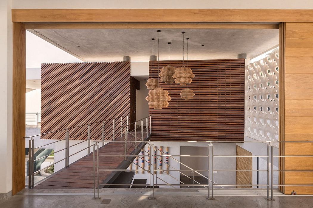 Wooden framework, suspended woven light fixtures, and a modern staircase with metal rails.