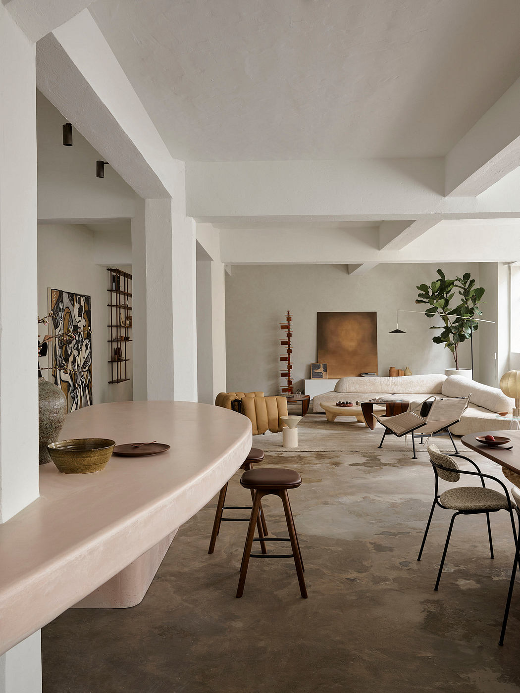 Spacious open-concept living area with neutral color palette, modern furnishings, and textural elements.