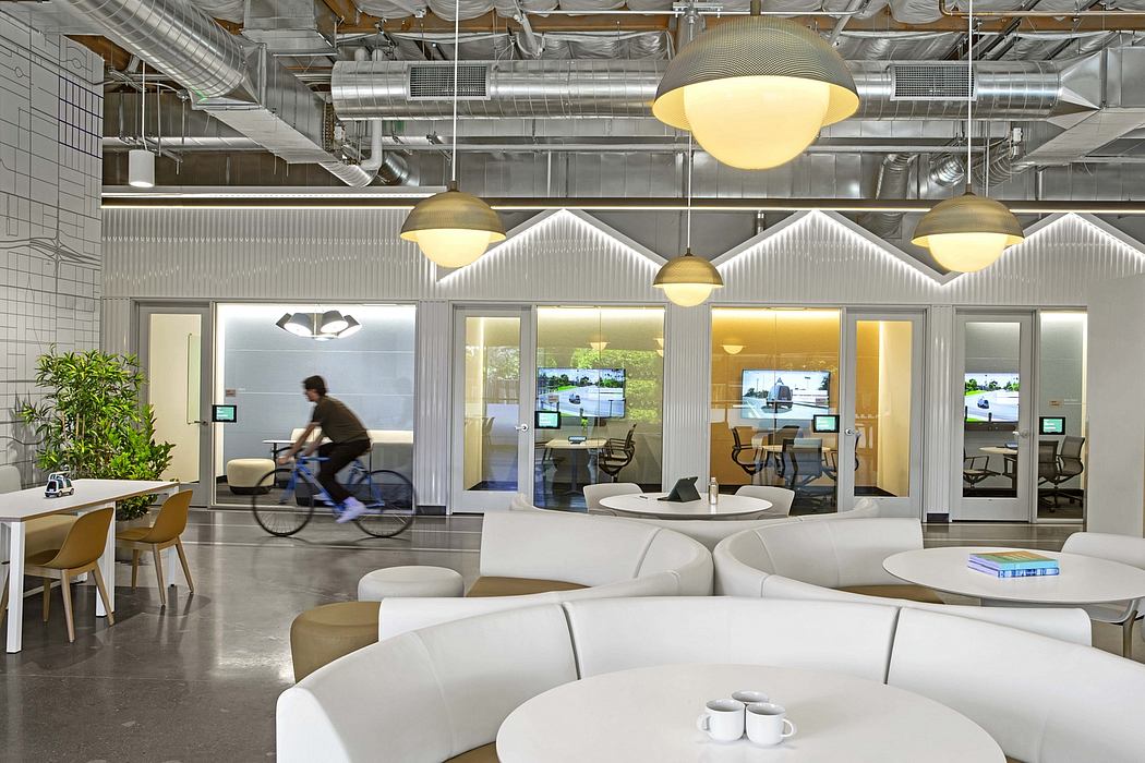 Sleek, modern office space with open layout, large windows, and stylish lighting fixtures.