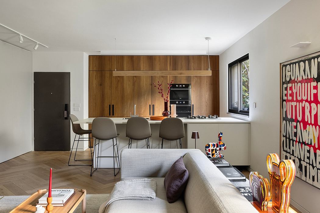 Modern open-concept kitchen with wooden cabinetry, bar stools, and striking graphic artwork.
