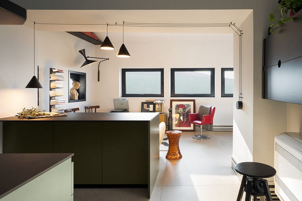 Sleek, modern interior with minimalist furnishings, statement lighting, and framed artwork.