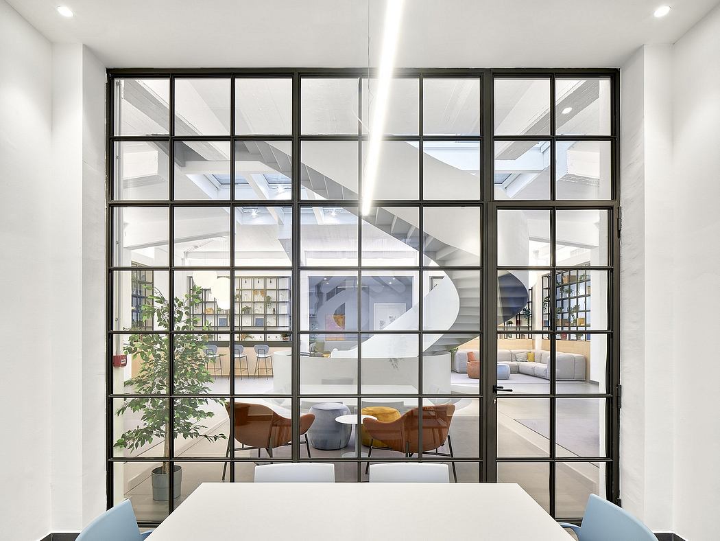 Spacious modern loft with large windows, minimalist furniture, and open-concept layout.