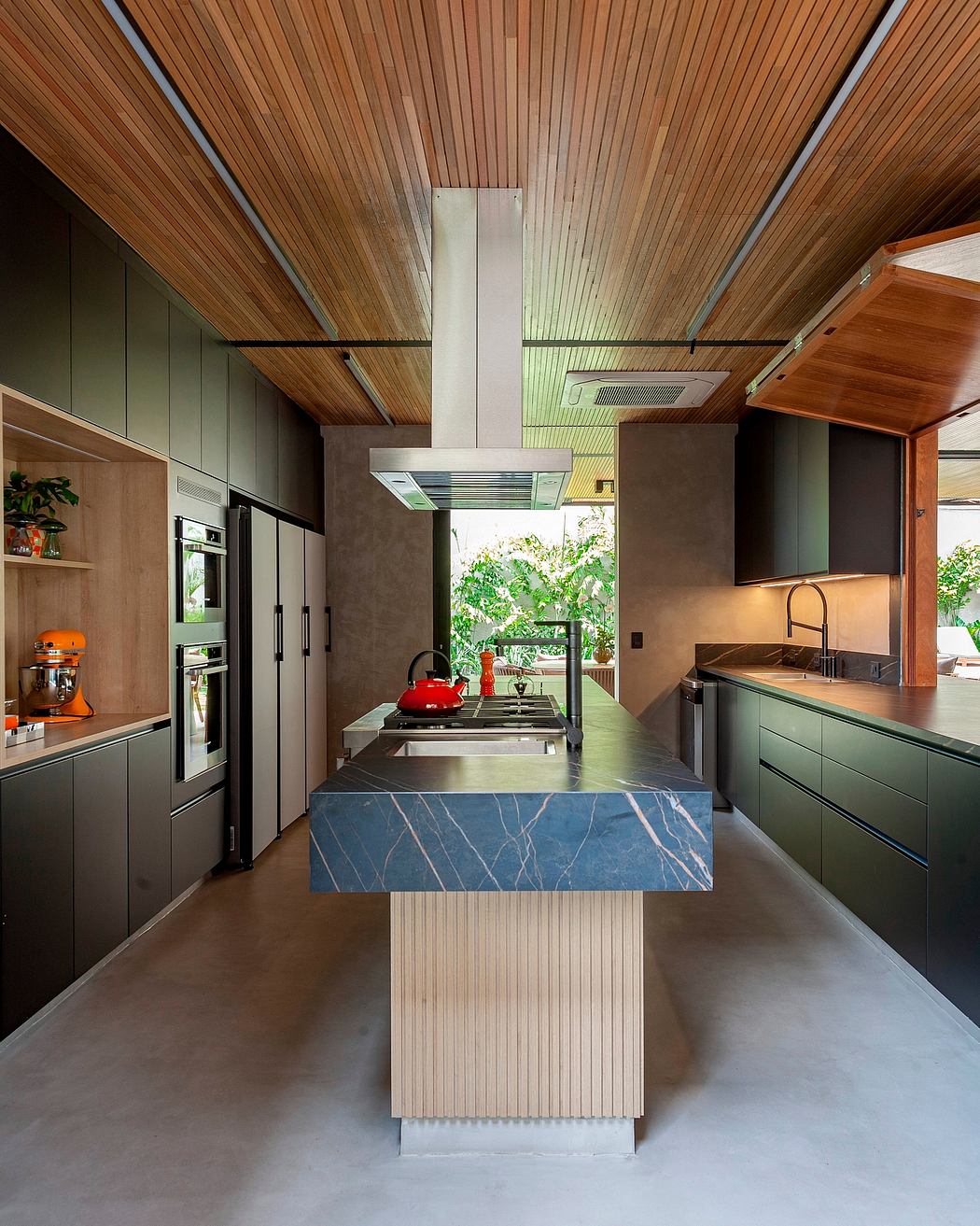 A modern kitchen with sleek cabinetry, a central island, and a wooden vaulted ceiling.