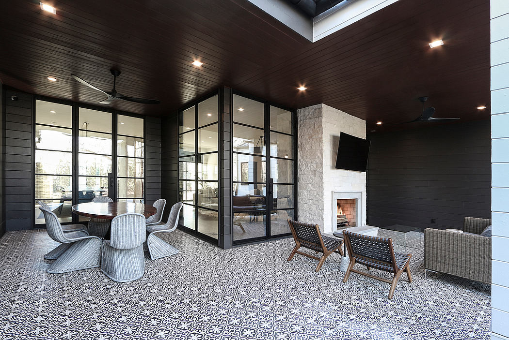 Expansive modern interior with patterned tile flooring, wood paneled walls, and fireplace.