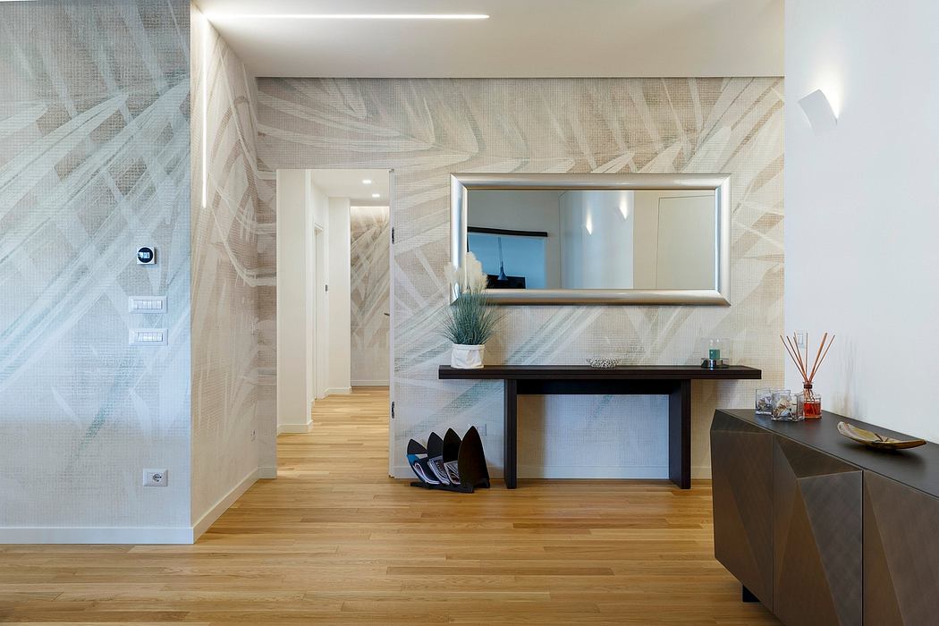 A modern, minimalist entryway with a wooden console, mirror, and hardwood flooring.