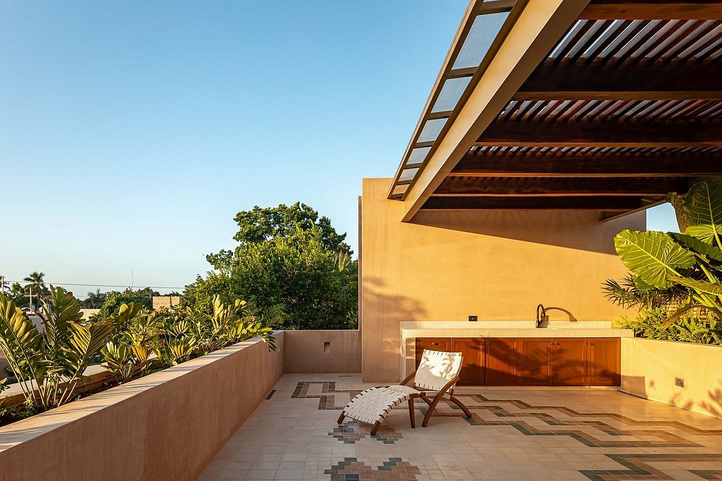 Cozy outdoor patio with tiled floors, wooden beams, and tropical greenery.