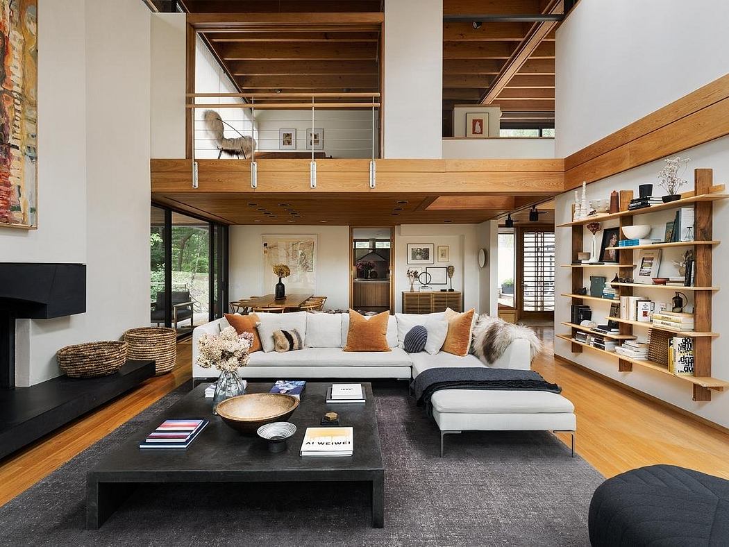 A modern living room with exposed wooden beams, built-in shelving, and a large sectional sofa.
