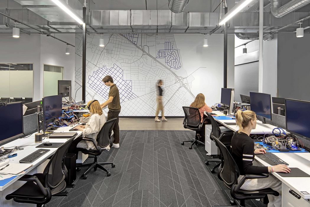 Sleek, modern office space with minimalist desks, chairs, and a large wall map graphic.