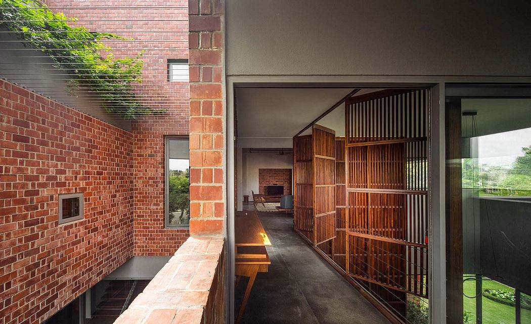 Brick facade with wooden lattice screens leading to an open interior space.
