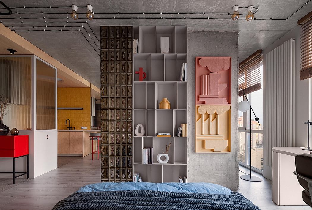 Modern industrial-style studio apartment with concrete walls, modular shelving, and statement lighting.