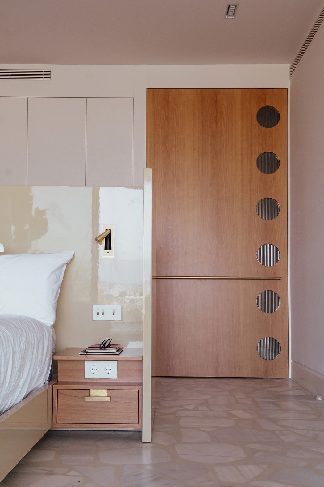Contemporary bedroom with wooden cabinetry, recessed lighting, and minimalist design.