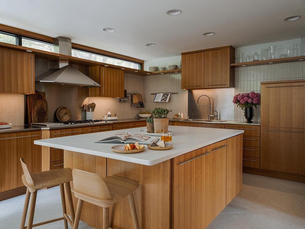 Warm wood cabinetry, large island, and open shelving in this modern kitchen design.