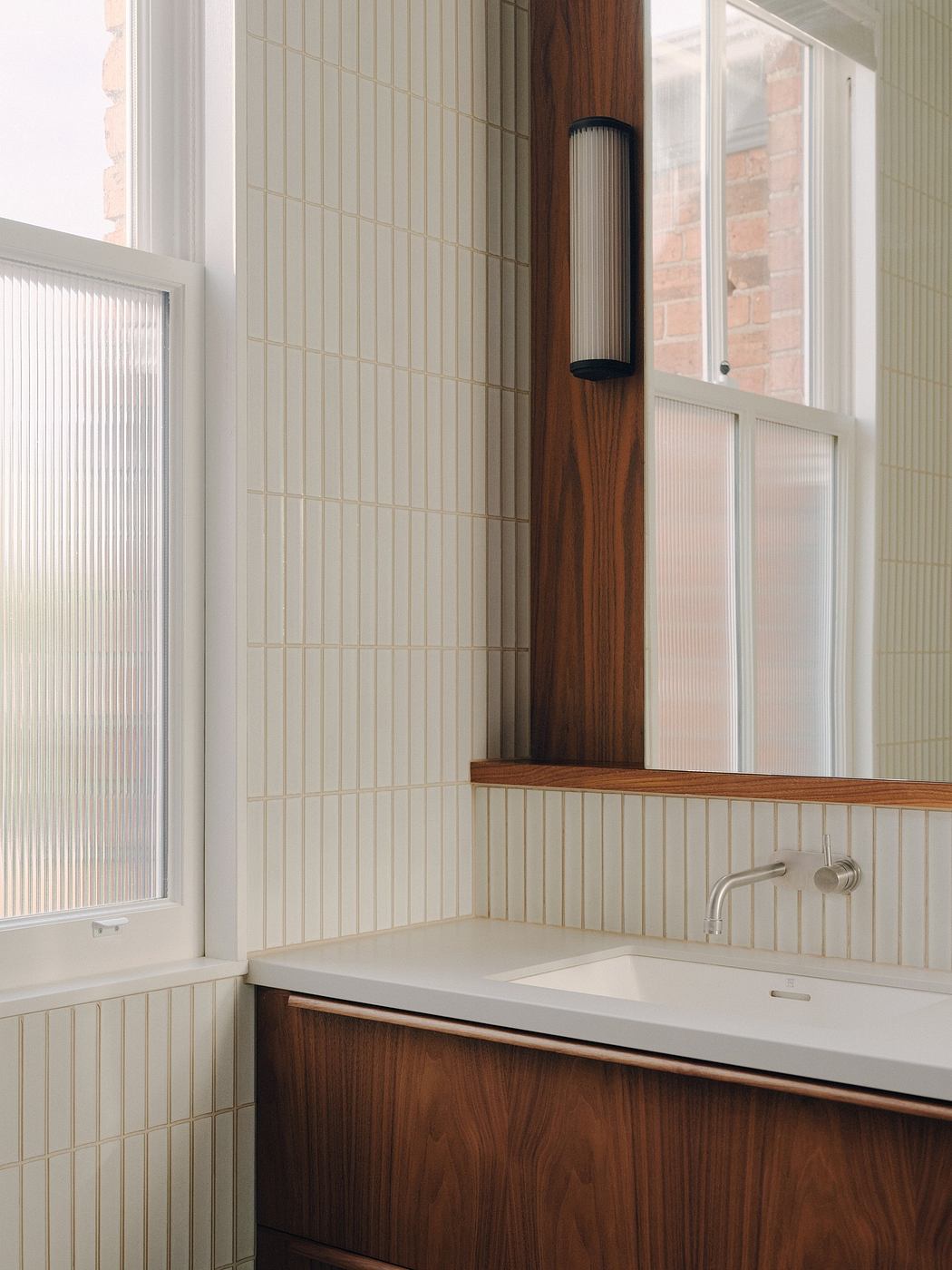 Sleek, modern bathroom features warm wood tones, minimalist fixtures, and clean lines.
