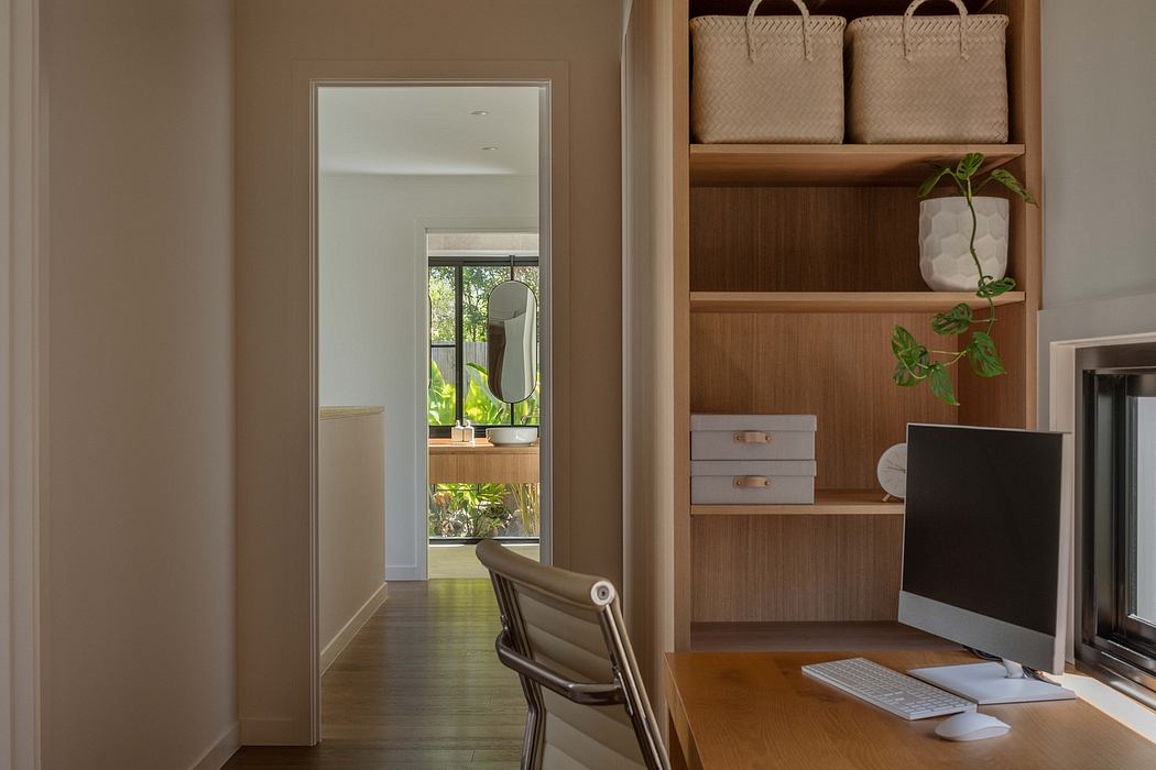 Cozy workspace with wooden shelves, potted plants, and natural light from windows.