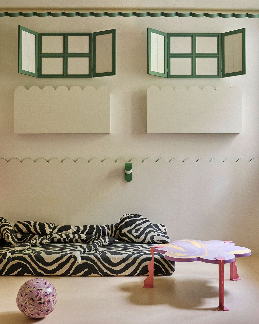 Minimalist room with green-framed windows, zebra-patterned sofa, and a unique coffee table.