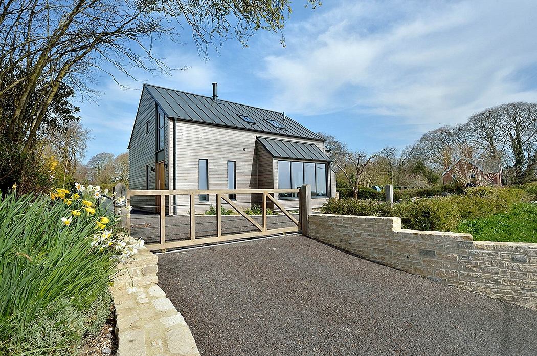 Charming modern wood-clad house with sleek metal roof and stone entrance path.