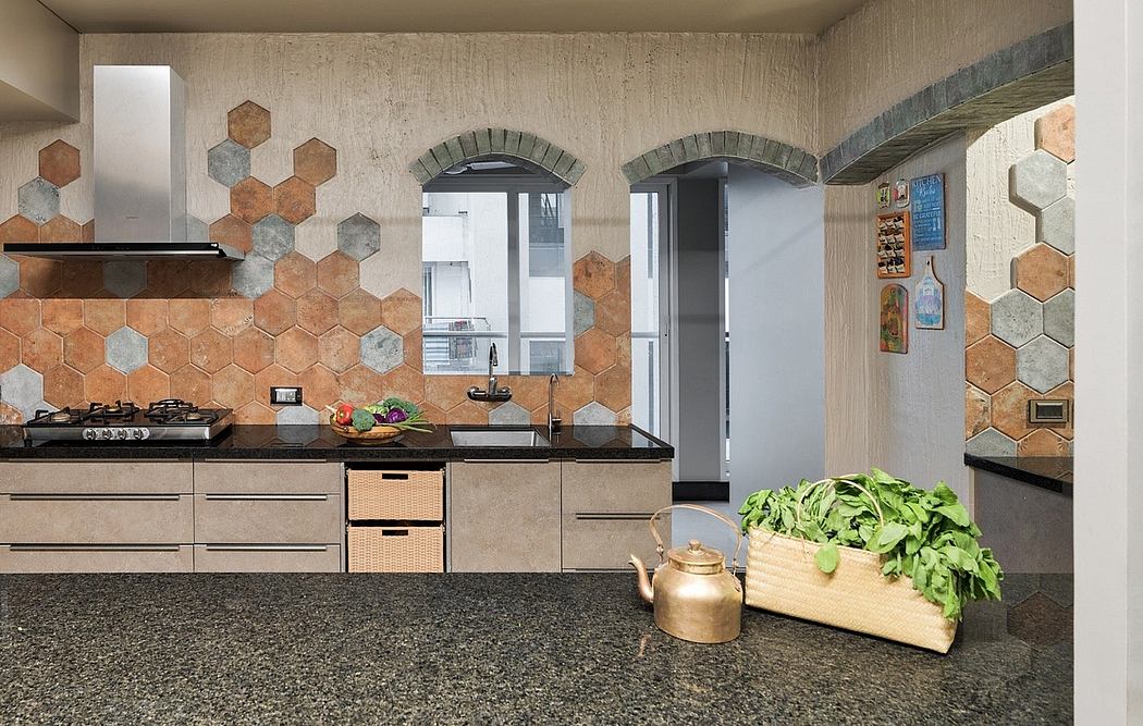 Modern kitchen with hexagonal tiles, arched doorways, and wooden cabinets against concrete walls.