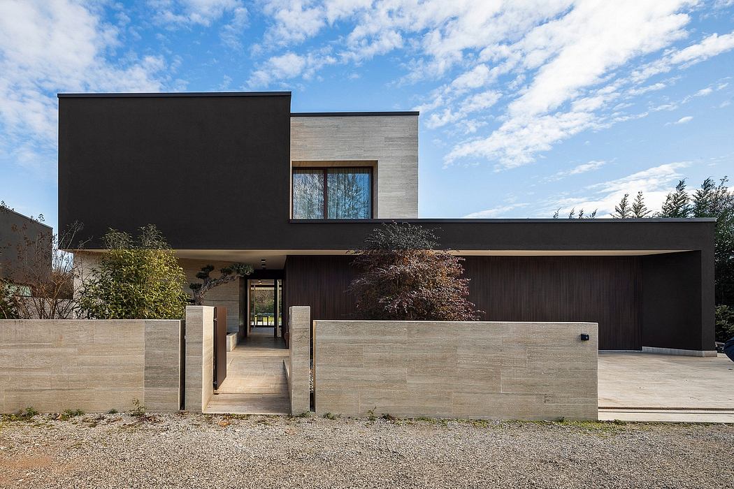 Modern, minimalist home design with clean lines, dark exterior, and stone accents.