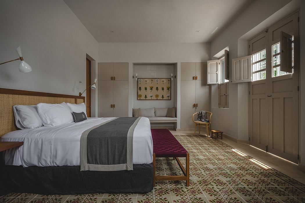 A modern bedroom with warm wooden accents, patterned flooring, and a cozy seating area.